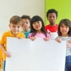 Diversity children holding blank poster in classroom at kindergarten Diversity Equity and Inclusion in STEM Board Members