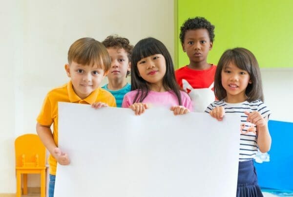 Diversity children holding blank poster in classroom at kindergarten Diversity Equity and Inclusion in STEM